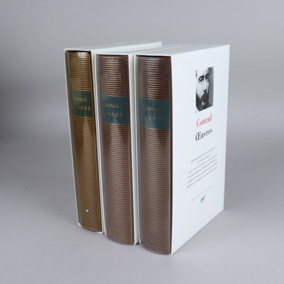 three books are stacked on top of each other on a table