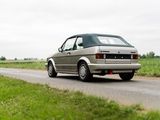 a car that is driving down the road in the country