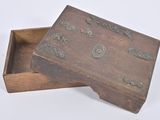 a small wooden box with metal decorations on it