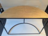 a small wooden table with a metal frame on top of it