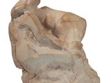 statue of a woman sitting on a rock with her legs crossed