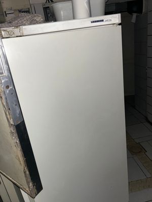 a white refrigerator sitting in a kitchen next to a counter