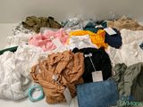 a pile of clothes and a purse on a table