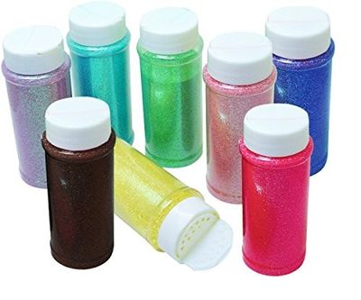 many different colors of glitter in bottles on a white background