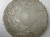 a white bowl with a design on it on a table