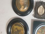 three framed pictures of a man and a woman are on a wall