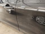 a close up of a car door handle with a sticker on it