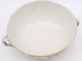 a white bowl sitting on top of a white table