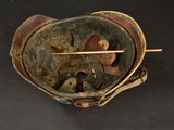 an old helmet with a wooden stick sticking out of it