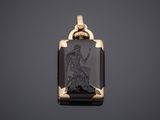 a gold and black onyxite pendant with an image of a woman