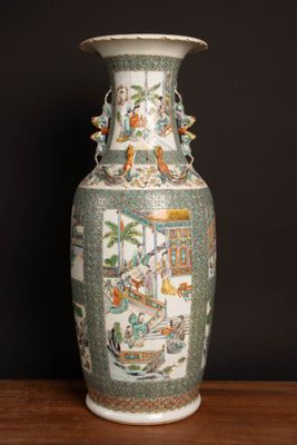 a vase that is sitting on a table in front of a black wall
