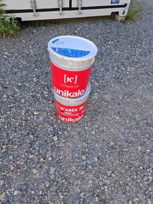 a bucket of ice sitting on the ground next to a truck