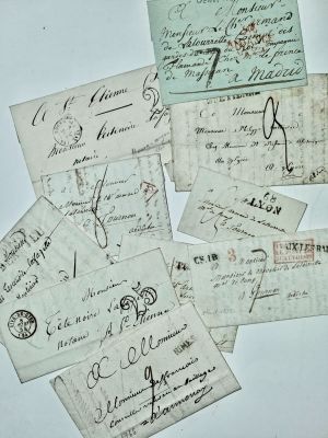 several pieces of old paper with writing on them on a table