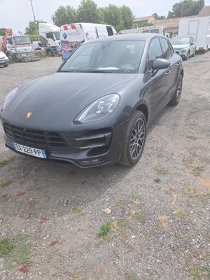 a black porsche cayen parked in a parking lot