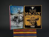 two books are stacked on top of each other on a black background