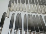 a lot of knives and knives that are on the table