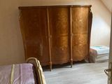 a bedroom with a bed and a dresser in it