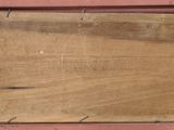 a wooden sign hanging on the side of a building