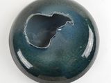 a picture of a blue and black bowl with a hole in it