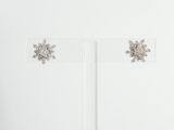 crystal snowflake stud earrings on clear acrylic stand