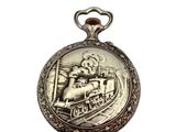 a silver pocket watch with a train on it
