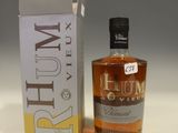 the bottle of rum is next to a box of rum