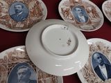many plates with pictures of people on them on a table