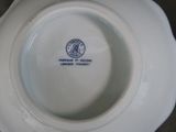 a white plate with a blue and white emblem on it