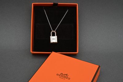 a close up of a necklace in a box on a table