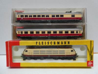 three model trains sitting in a box on a table