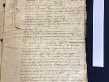 an old document with writing on it sitting on top of a table