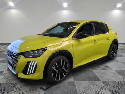 a yellow car is parked in a room with a checkered floor