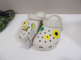 a pair of crocs with sunflowers on them