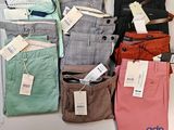 a lot of men ' s pants on display on the table