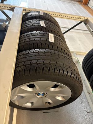 the wheels of a car are stacked on a rack in a garage