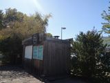 a small wooden building with a sign on it