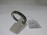 an image of a silver ring with black stones on a white surface