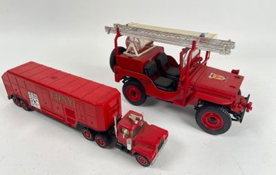 two toy trucks that are sitting next to each other