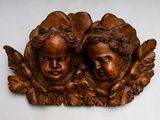two carved angels on the wall of this room