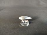 a close up of a silver object on a black surface