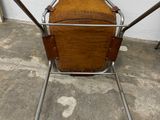 a wooden chair with metal legs and a wooden seat