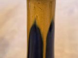 a black and yellow vase sitting on a table