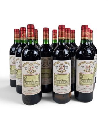 six bottles of wine are lined up in a row on a white surface