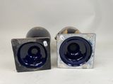 pair of blue glass vases on a white background