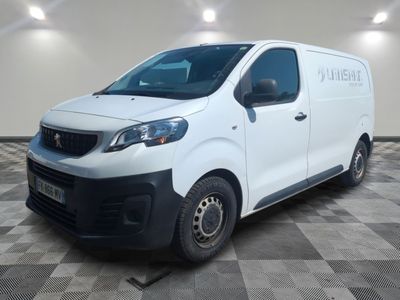 the white van is parked in a large room with a checkered floor