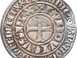 a close up of a coin with a cross on it
