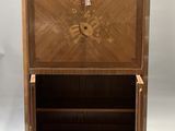an antique wooden cabinet with drawers and a shelf on top of it