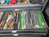 many different tools in a metal case on a table