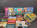 a pile of children ' s books sitting on top of a table