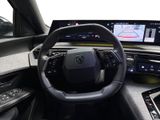 the interior of a car with a steering wheel, dashboard, and display screen